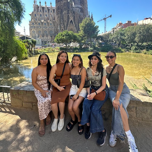 Group of students sitting in front of a Cathedral in Madrid